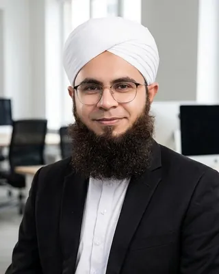 Jafar Suleman, Founder and CEO of JSK LOGICS, in a white turban, glasses and a dark suit